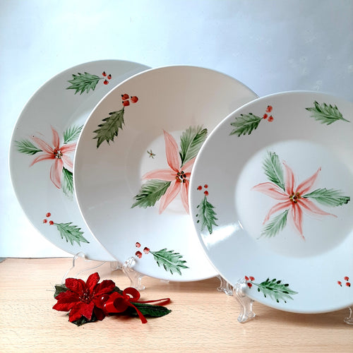 he tableware features Christmas motifs, such as the striking and unique red poinsettia flower, adding cheer to any table setting.